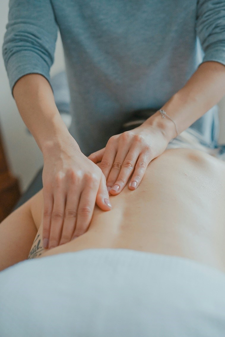 Person working on a client’s back.