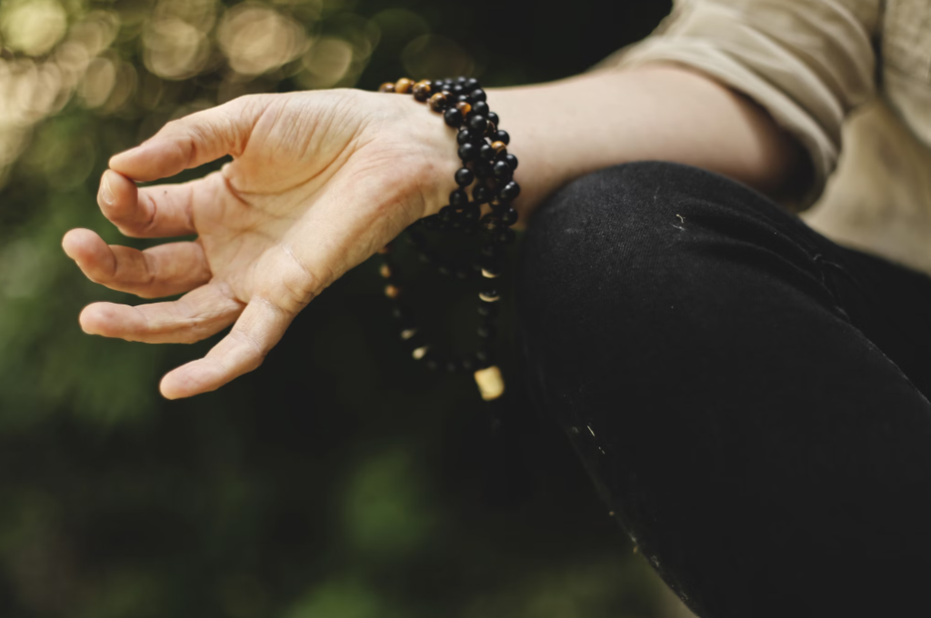 A person meditating outdoors.